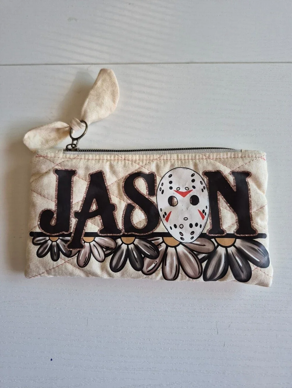 Creme slasher w/ flowers Quilted bow pouch w/ bow zipper pull accent